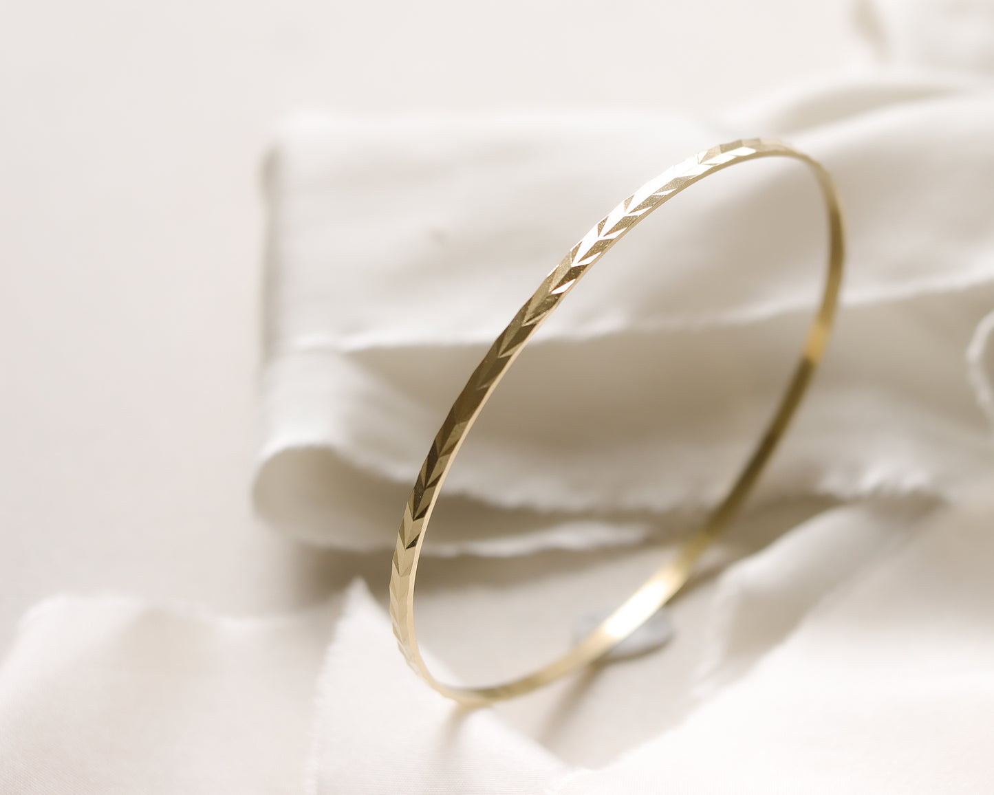 9ct gold chevron patterned bangle