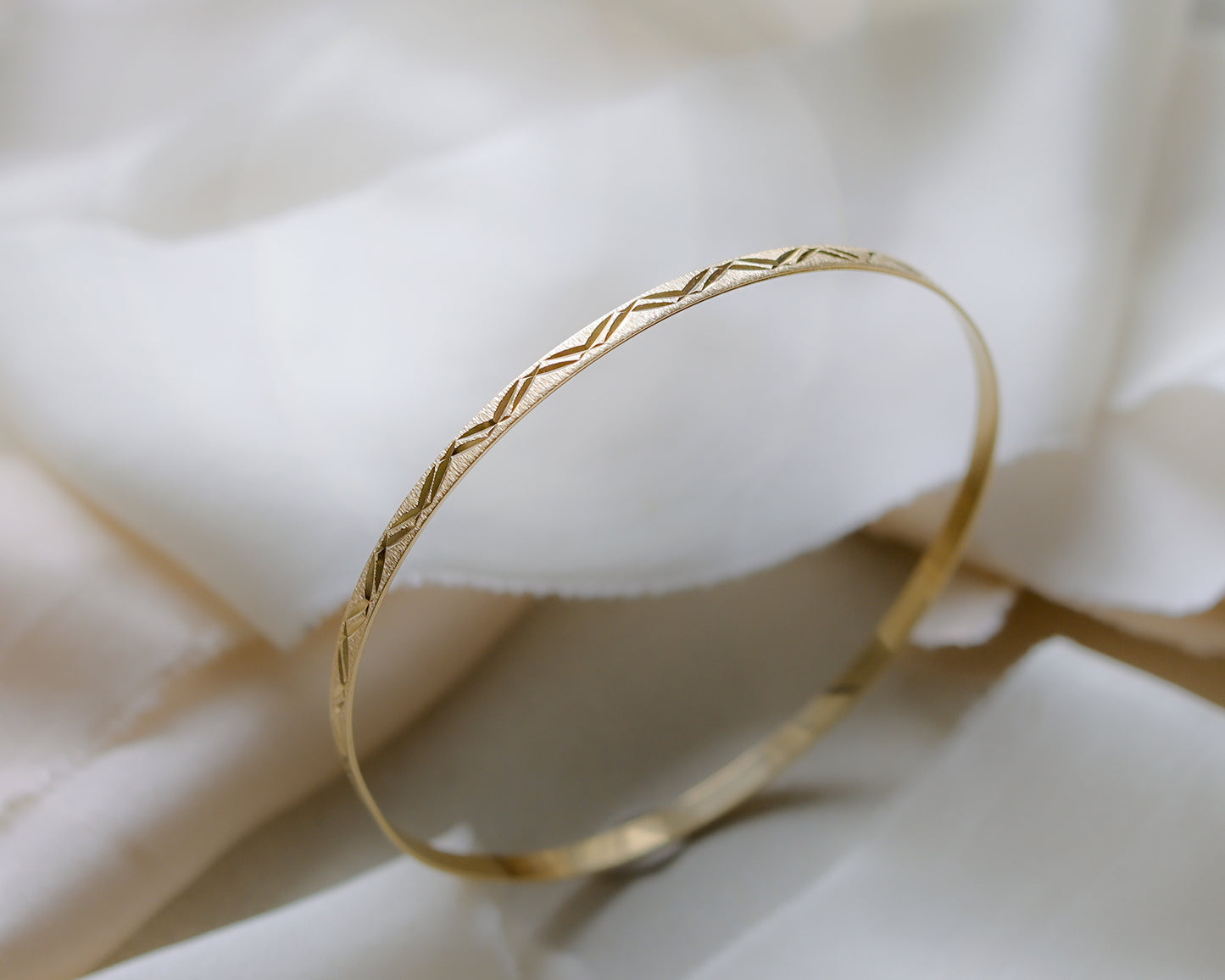 9ct gold textured, engraved bangle